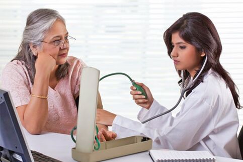 a doctor measures blood pressure in hypertension